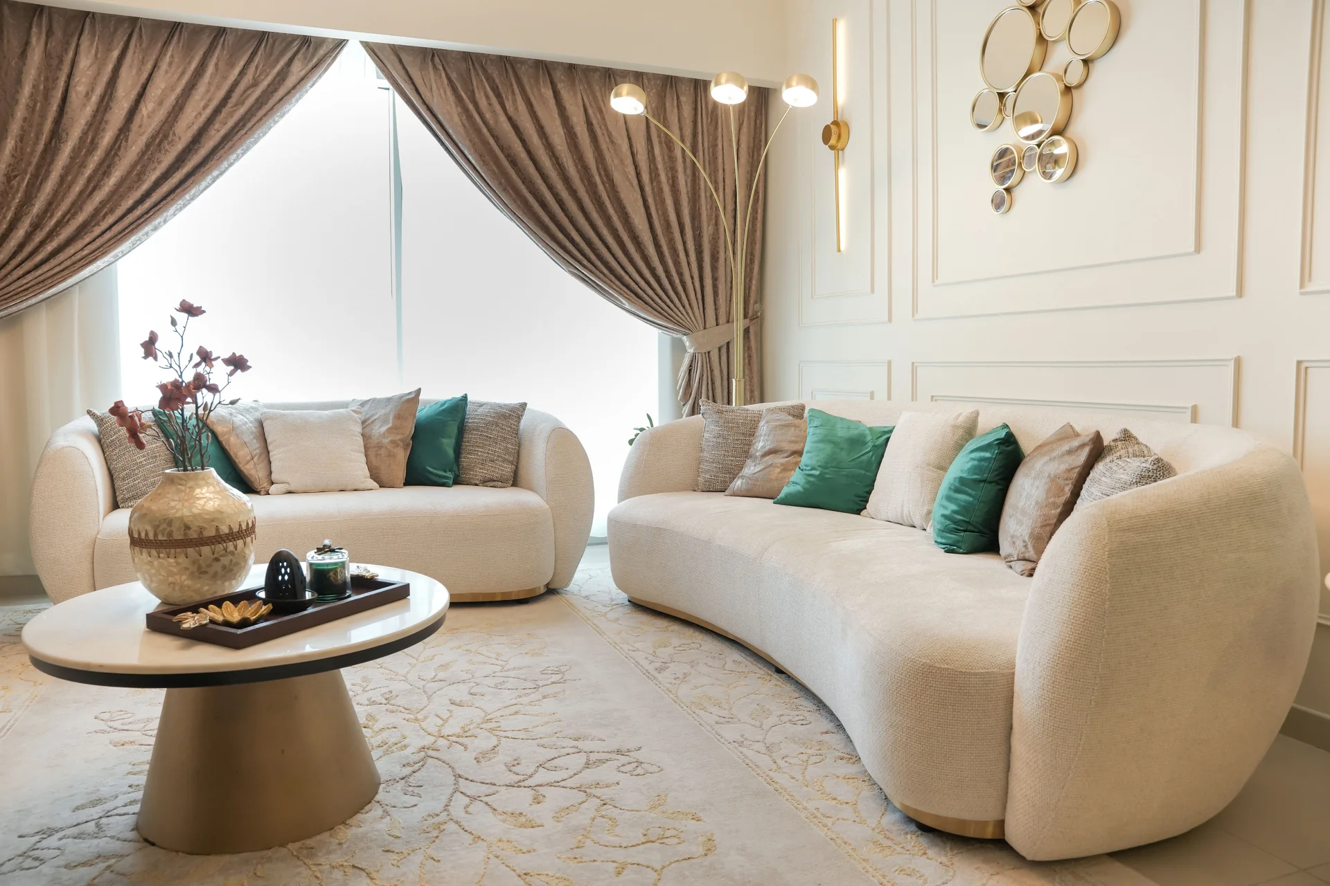 Gate Tower apartment living room with a curved sofa and decorative wall panelling