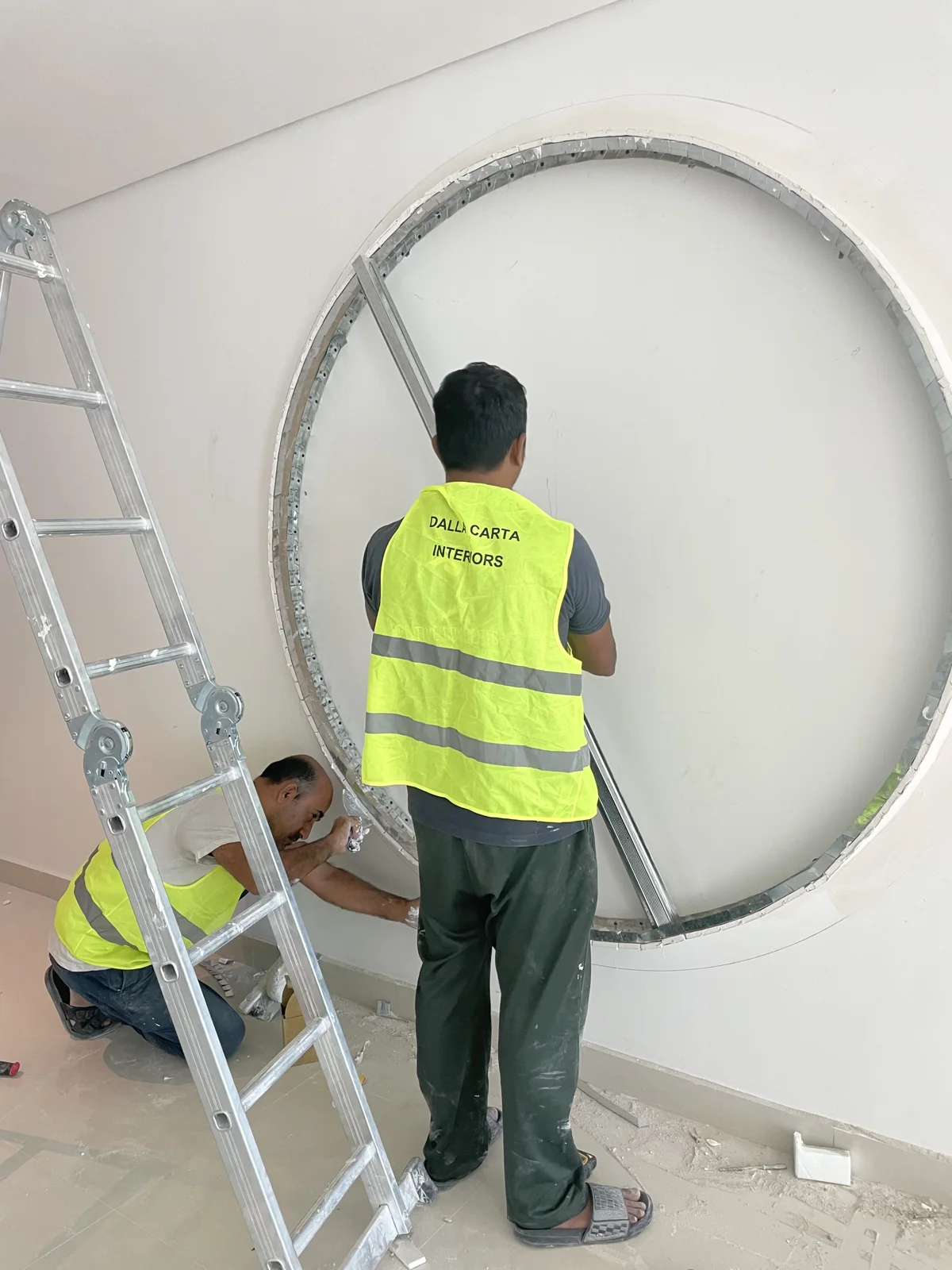 Dalla Carta team forming a circular interior wall feature